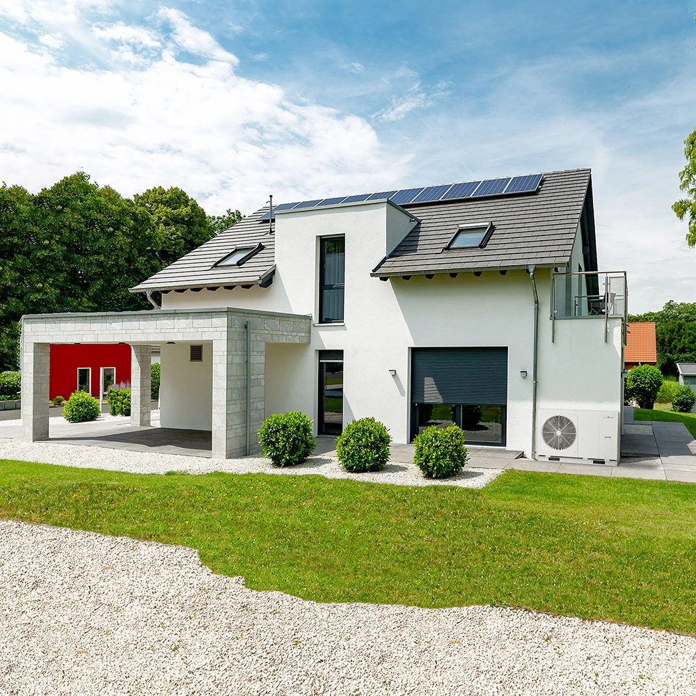 Image of an air source heat pump installed outside a modern home